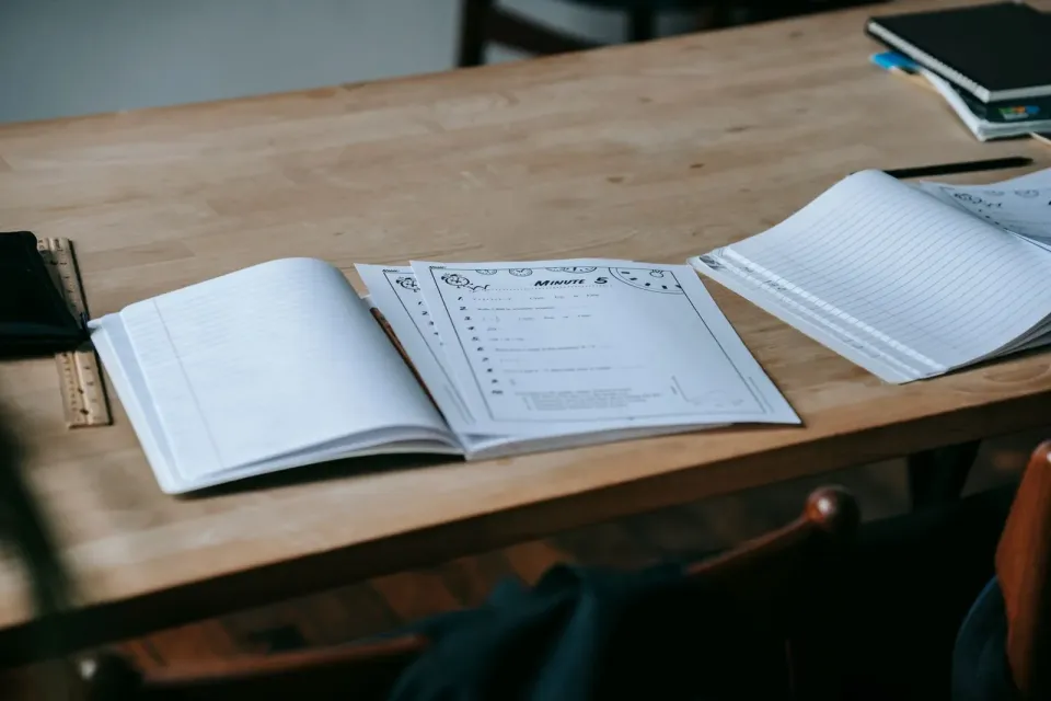 Programme workbooks open on a table