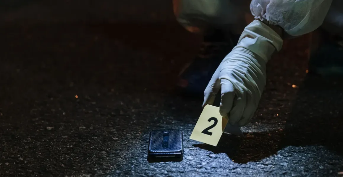 Forensic investigator collecting evidence at a nighttime scene, representing investigative work linked to cocaine trafficking