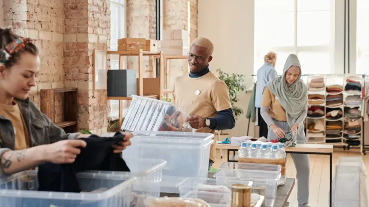Volunteers organizing donations at a community center, illustrating nonprofit organizations work related to FATF Recommendation 8