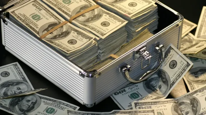 Briefcase full of dollar bills representing the physical transport of cash and negotiable bearer instruments